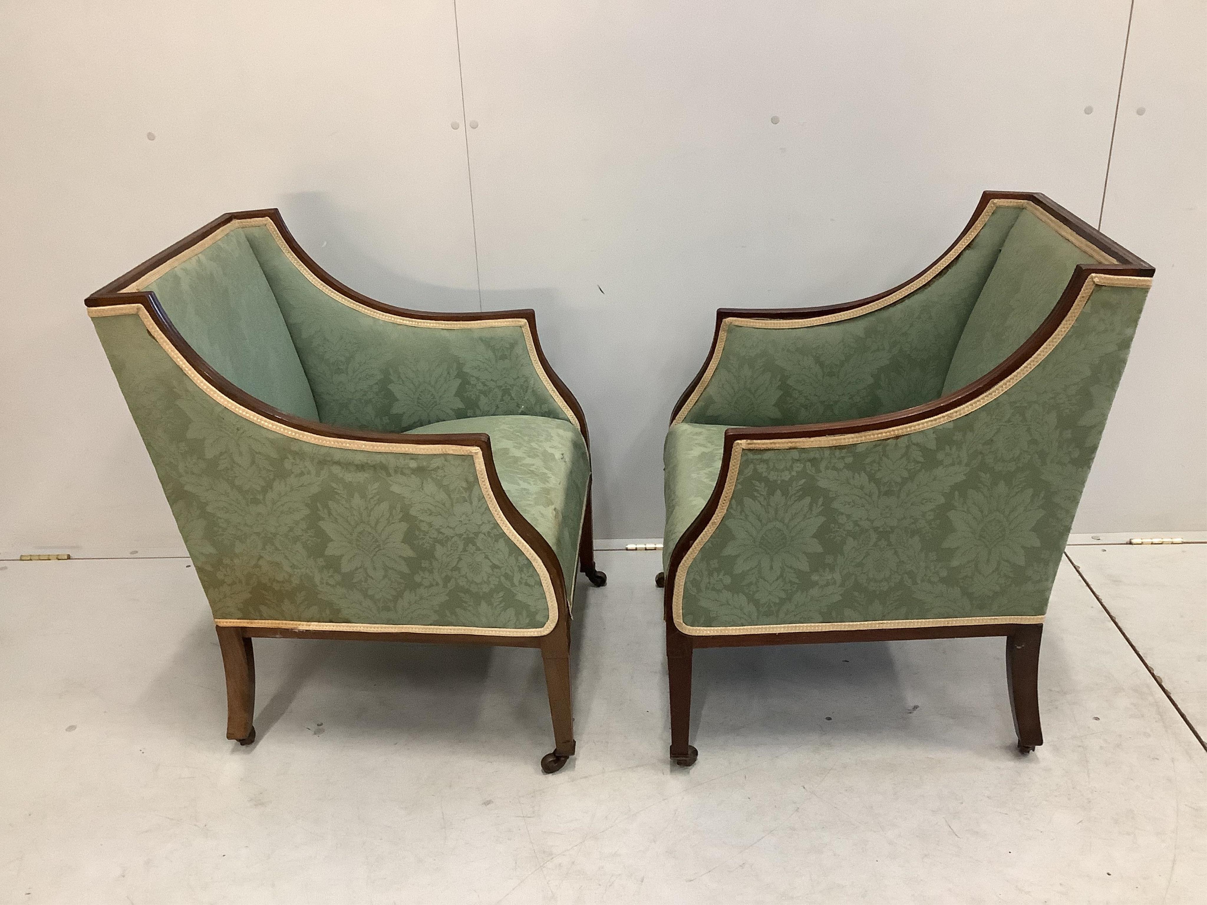 A pair of Edwardian mahogany armchairs, width 59cm, depth 55cm, height 79cm. Condition - fair, upholstery poor